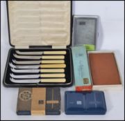 Two vintage 20th century cigarette cases along with a set of cased cheese knives and other items