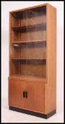 A 20th century oak upright library bookcase cabinet having sliding glass cabinet over cupboard