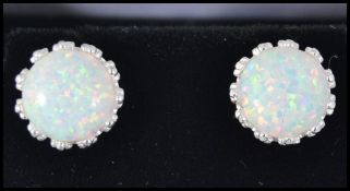 A pair of silver and opal adorned ladies contemporary earrings - ear studs complete in the