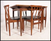 A set of 4 good 1970's teak dining chairs having original pad seats with angular railed back rests.