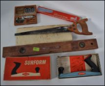 A collection of vintage tools to include spirit measure, saws,