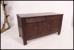An 18th century country carved oak English coffer - blanket box chest raised on stile supports with