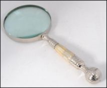 A large good quality silver plated and mother of pearl inset magnifying glass having finial end to