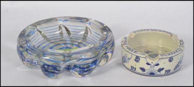 A stunning mid century studio art glass dish with blue glass swirl centre together with a delft