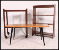 A retro 1970's coffee table raised on dansette legs together with a mahogany open window bookcase