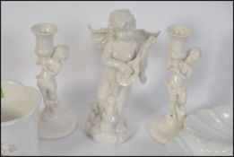 A collection of china to include a cherub figurine and cherub candlesticks etc.