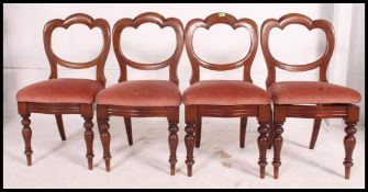 A set of 5 Victorian mahogany balloon back dining chairs being raised on turned legs with drop in