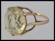 A 9ct gold and large citrine stone ladies cocktail dress ring. The large stone on claw mount.