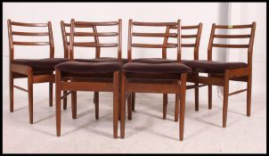 A good set of 1970's Danish influence teak dining chairs having railed back rests,