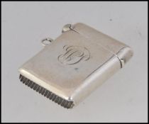 A silver hallmarked vesta case with monogram to centre.