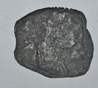 An 18th century Spanish reale coin of metal form being heavily beaten bearing the head of Carolus