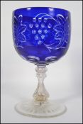 A 20th century over sized etched and cut glass goblet of Bohemian / Bristol blue style.