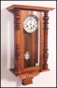 A 20th century mahogany cased walnut vienna regulator wall clock in the manner of Gustav Becker