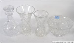 A cut glass Edinburgh Crystal decanter along with a Stuart decanter and matching glasses.