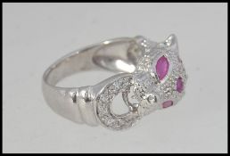 A silver Cartier style panther ring being inset with semi-precious stones. Total weight 5.