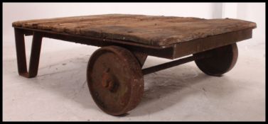 A vintage industrial early 20th century Bogie trolley, having cast iron wheels,