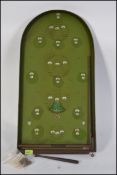 A good early 20th century bagatelle board with green background, wooden frame,