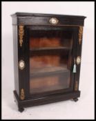 A 19th century ebonised pier - bookcase display cabinet.