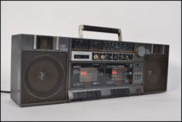 A retro 1980's Saisho ghetto blaster having twin speakers with twin cassette deck