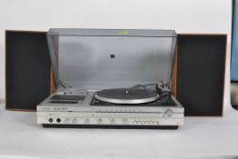 A retro 1970's Hi-Fi entertainment unit by Ferguson having inset record deck complete with speakers