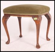 A early to mid 20th century piano stool, having an over stuffed pad,