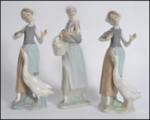 A collection of three Lladro porcelain figurines,