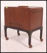 A retro 1950's mahogany sewing box having dome top being raised on squared legs with lined interior
