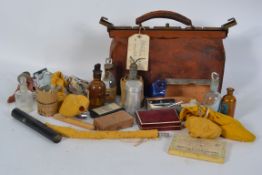 An Edwardian leather gladstone doctors bag complete with the contents to include instruments,