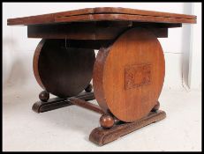 An excellent large 1930's Art Deco oak refectory draw leaf dining table raised on roundel pedestal