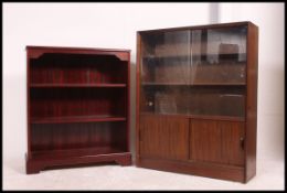 An oak 1970's bookcase cabinet together with a mid century sliding glass bookcase cabinet ( see