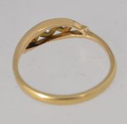 A vintage Art Deco 18ct gold three stone diamond ring . Marked 18ct. Tests 18ct. Size M.5.