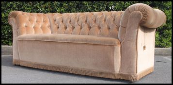 An early 20th century double drop end chesterfield sofa settee upholstered in beige velour with