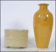 A Chinese monochrome yellow vase adorned with fu-dog masks and incised decoration of dragons and