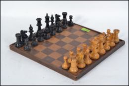 A Victorian satinwood and ebony chess set complete with the board, possible a club set,