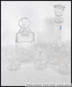 Two 20th century cut glass decanters with stoppers along with a set of four matching cut glass