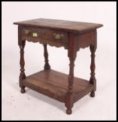 An 18th century lowboy stool table. Country oak with turned legs having lower tier.