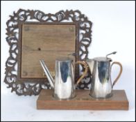 An unusual Silver plate hot water service by Harrods set to a wooden plinth taken from Weston Super