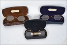 A set of 3 vintage gentlemans spectacles each with the cases and testing for 9ct gold.