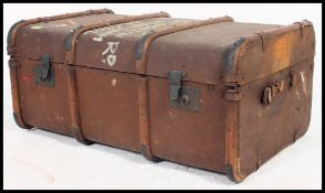 An early 20th century ebonised canvas and wooden bound steamer trunk ,
