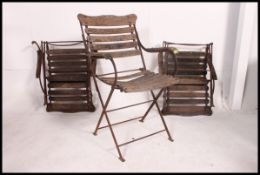 A set of 3 early 20th century folding garden teak and wrought iron garden chairs.