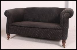 A Victorian mahogany chesterfield sofa having barrel arms being upholstered in a blue fabric and