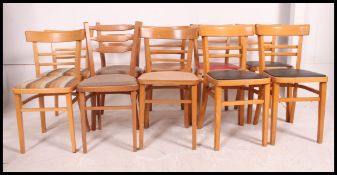 A harlequin set of 10 1970's beech wood utility kitchenette - dining chairs raised on squared legs