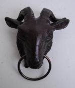 A cast iron wall hanging animal stay / lead tie in the form of a goats head.