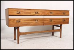 A 1970's Meredew maple two tone sideboard / dresser raised on tapering supports having a low and