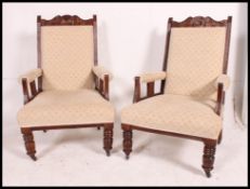 A pair of late Victorian parlour mahogany open arm chairs,