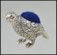 A 20th century silver pin cushion in the form of a partridge / game bird having inset cushion top.