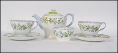 An early 20th century Shelley harebell flower chintz pattern teapot together with 2 trios and a