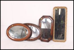 A collection of mirrors dating from the early 20th century to include oval mahogany,