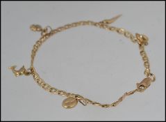A hallmarked 9ct gold charm bracelet with daolphin coffee bean heart and horn of plenty four leaf