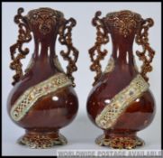 A pair of 19th century bargeware style Majolica vases being stone glazed with embellishments H37cm